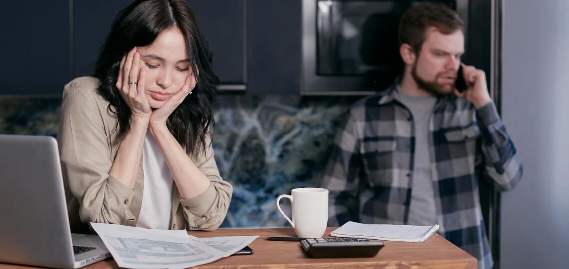woman in white long sleeve shirt sitting beside man in black and white checkered dress shirt